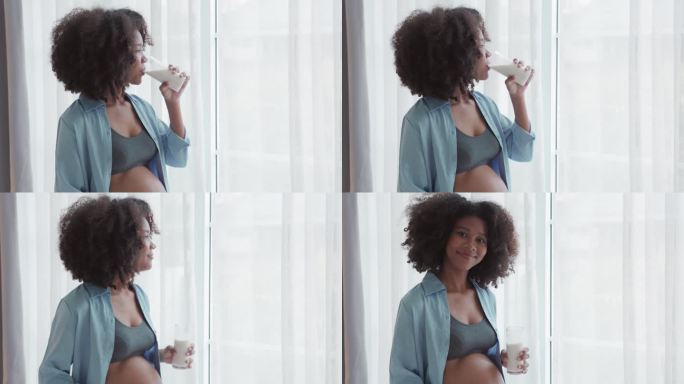 快乐的非洲孕妇喝着牛奶，抚摸着她的肚子