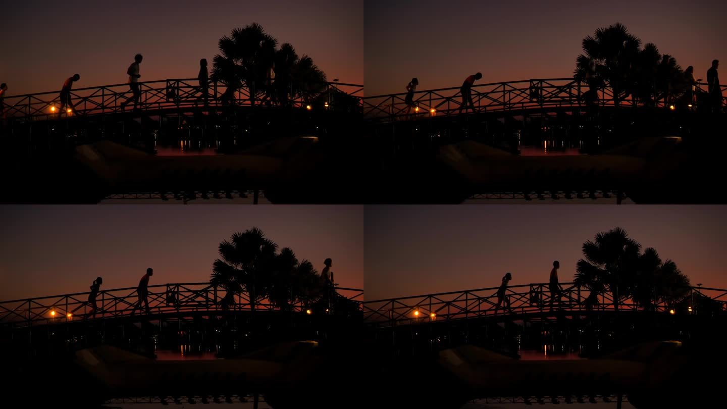 人们在桥上奔跑的剪影。