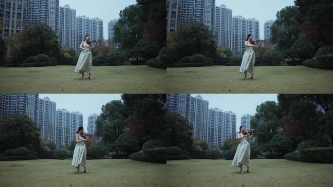 美女在住宅小区草坪上拉小提琴
