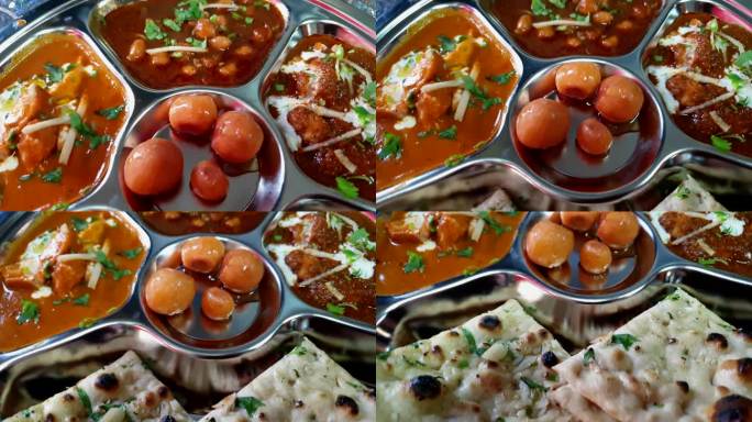 印度著名的咖喱装在银盘里，配上泡菜、黄油、鸡肉和印度沙拉