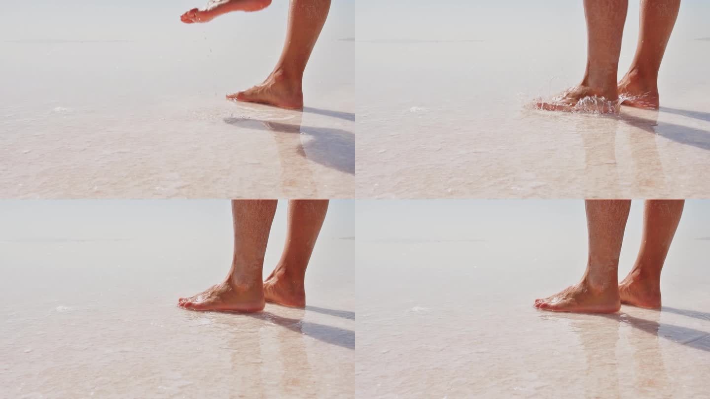 静态特写，女性的脚溅起白色的盐湖水。赤脚走在盐湖上