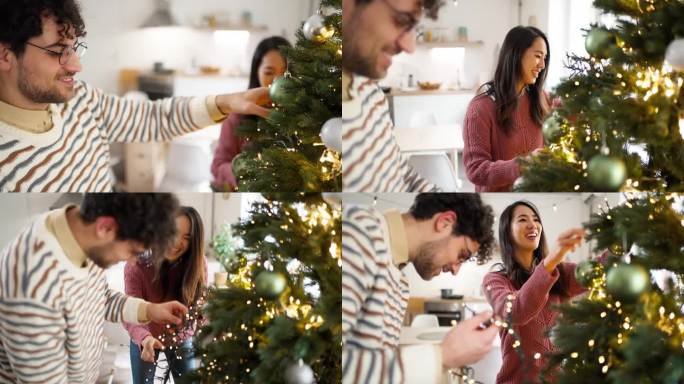 多种族夫妇，高加索男人和日本女人，在家里装饰圣诞树