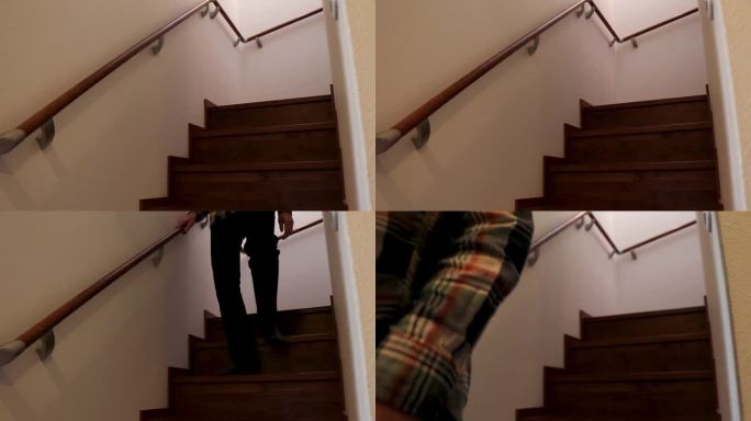 一个穿着便服的男人从楼梯上走下来