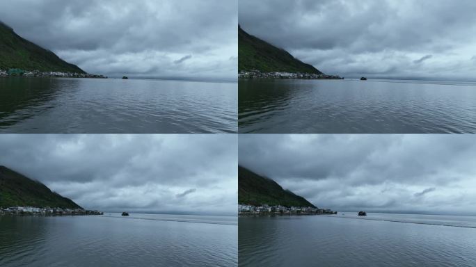 无人机沿湖面飞行大理洱海雨天风景朦胧美