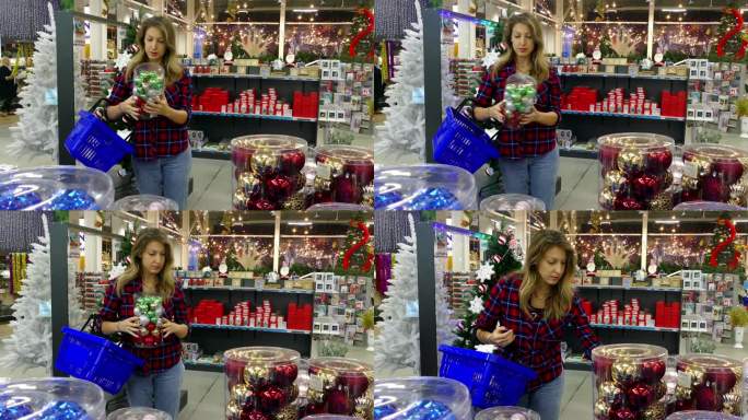 在商店里挑选圣诞树装饰品的年轻女子