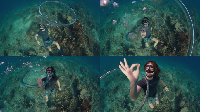 自由潜水员在水下制造环状气泡并与之玩耍