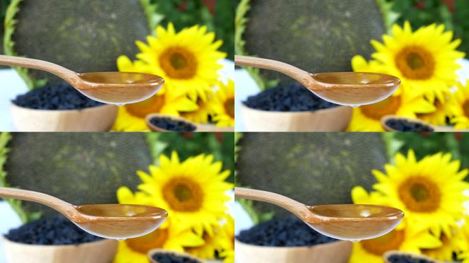 用木勺舀上葵花籽油，再从勺底滴上一滴油。