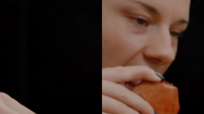 垂直视频。桌上摆放着成熟多汁的石榴，背景是一位年轻女子正在吃一块石榴。缓慢的运动。