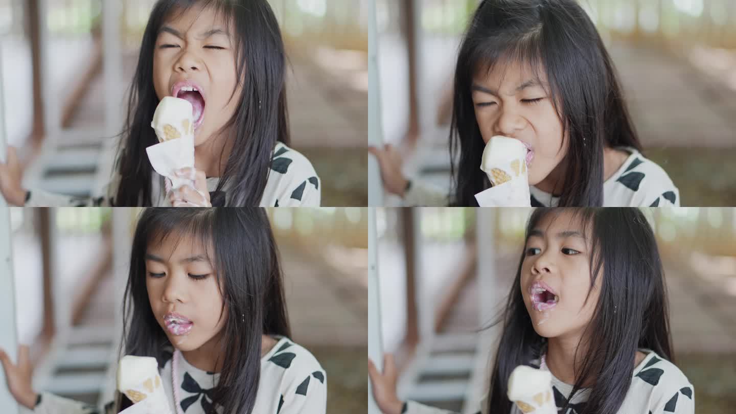 小女孩在享用他们的甜筒冰淇淋。