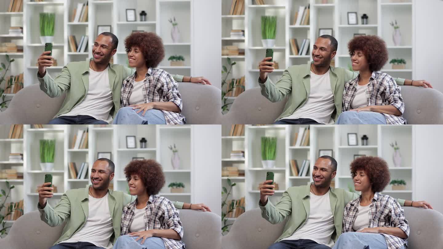 年轻的家庭夫妇在家里视频通话。快乐的远方朋友通过网络摄像头在虚拟应用中在线聊天，享受生活方式的交流。