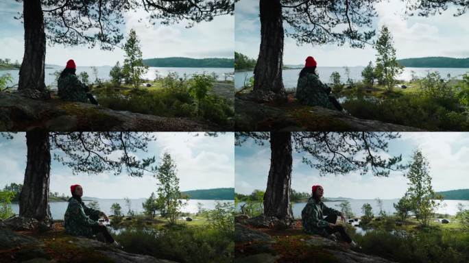 孤独的红帽女人独自在岩石上休息，看湖的风景，放松和冥想