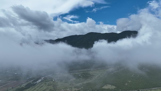 航拍山间乌云密布露出蓝天白云云海丽江