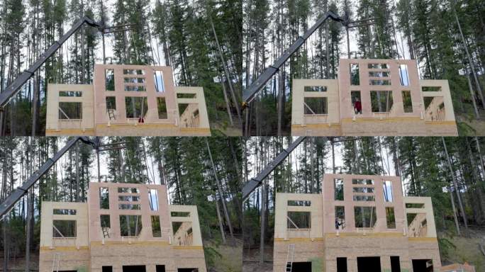 吊车帮助竖立房屋前墙的景象