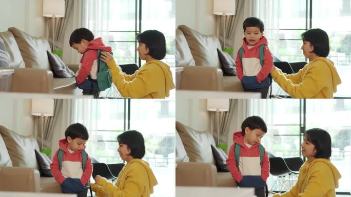 亚裔华裔母亲帮小儿子整理书包