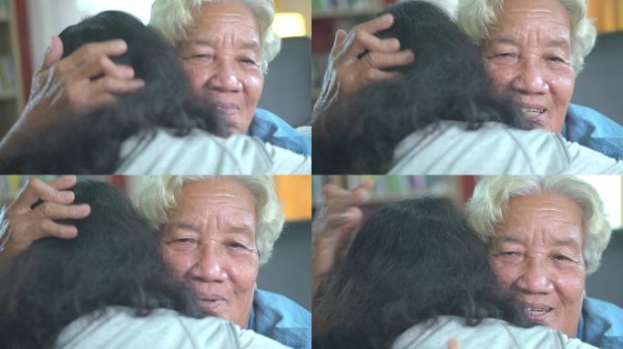 亚洲奶奶和孙女拥抱，以表达他们对彼此的爱和关心。