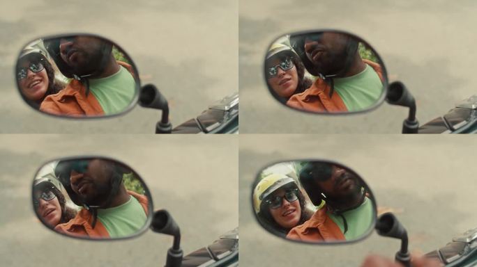 男人和女人骑摩托车时后视镜里的倒影