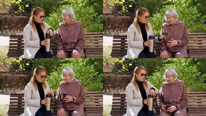 一个成年的孙女从长凳上的保温瓶里给年老的祖母倒茶
