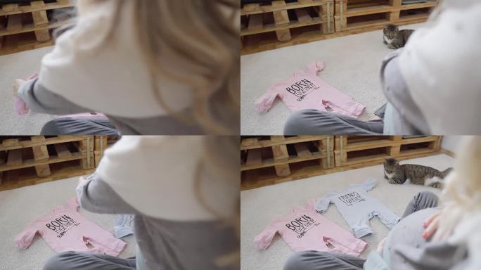 孕妇准备她的新出生的孩子准备婴儿布，高角度拍摄库存视频