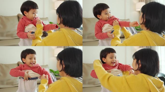 亚洲华人母亲给儿子穿衣服