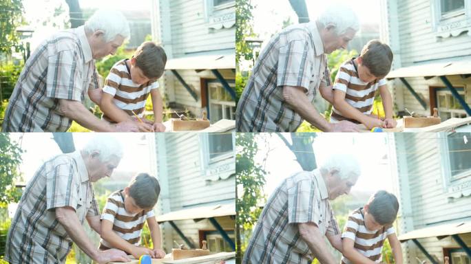 一位白发苍苍的老人在户外教一个男孩做木工活。爷爷教孙子做木匠，用尺子量木板，用铅笔划线。
