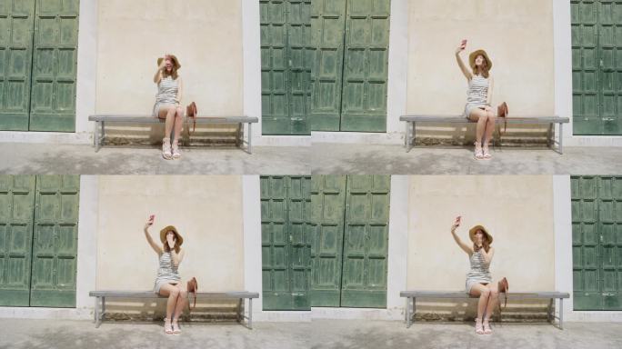 快乐女孩在手机摄像头前挥手，分享在意大利小镇的欧洲夏日旅游度假冒险