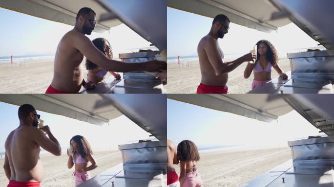 父亲和女儿在海滩上的一个售货亭举杯庆祝