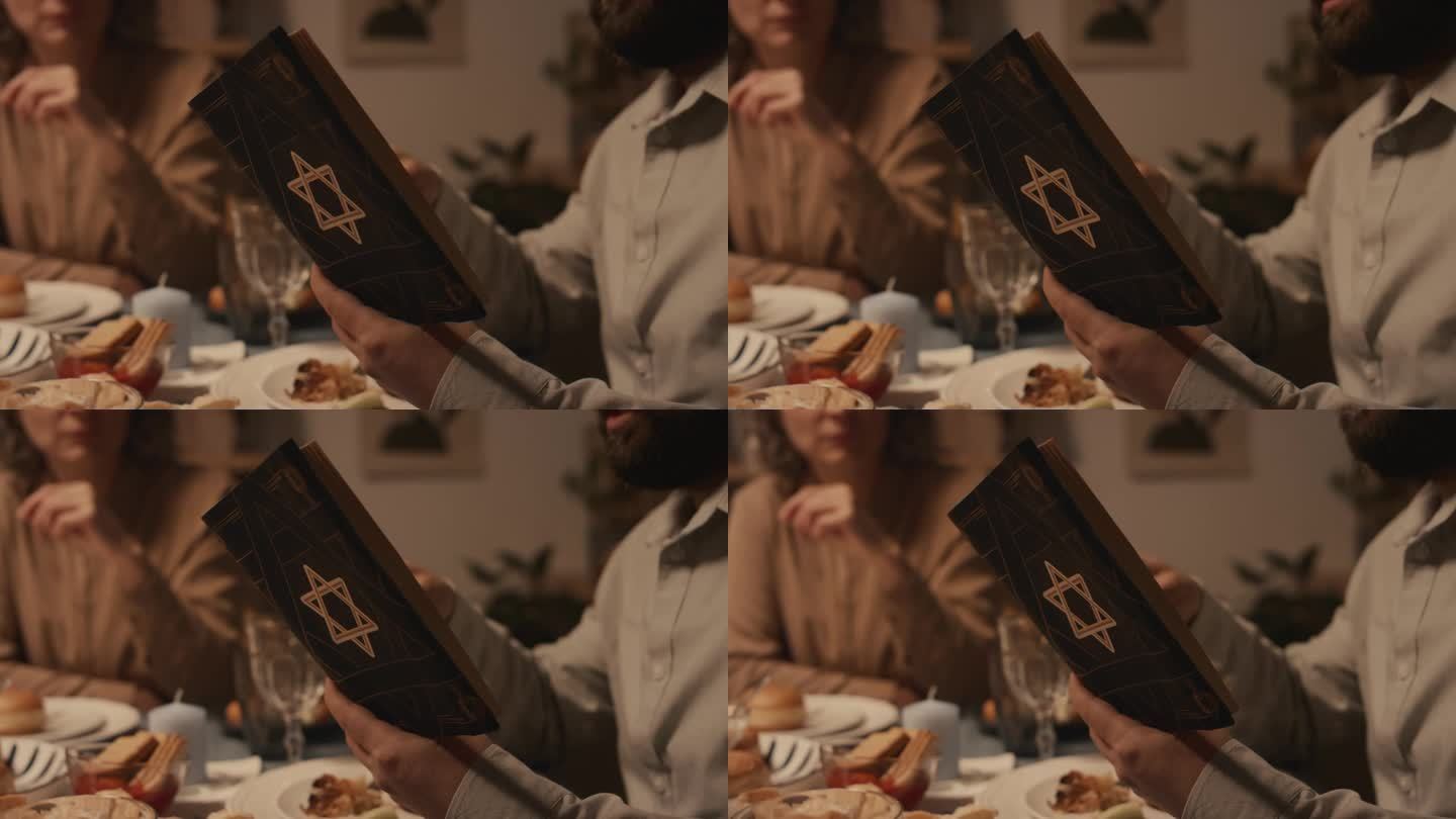 在家庭晚餐上，犹太男子的手阅读《托拉》中的段落