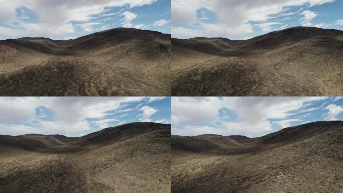 在干燥的丘陵地带上空飞行。干旱气候地区贫瘠土壤鸟瞰图。杳无人迹的荒凉之地。美国加州