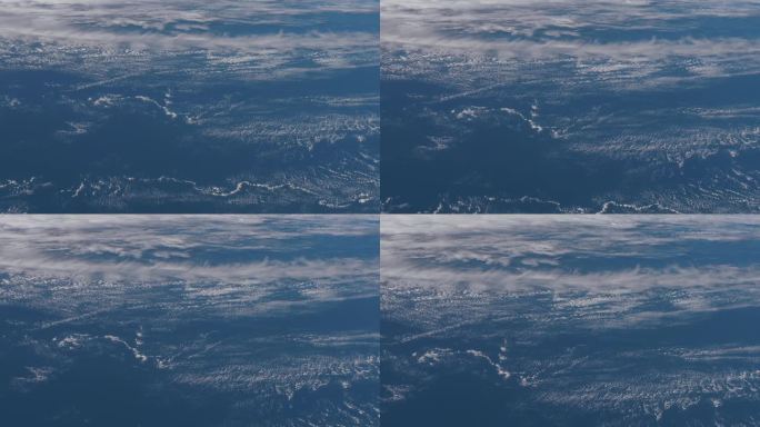 从飞机上看，云海一片。抽象冰表面冻成蓝色的海、湖、海。