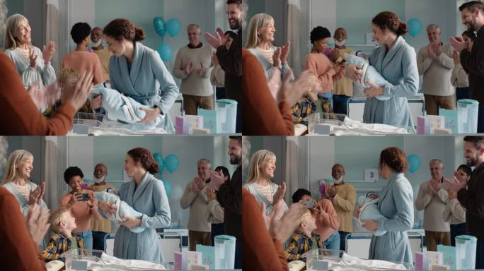 家庭，掌声和一位母亲与她的孩子在医院一起庆祝出生或新生命。爱心、微笑和快乐的朋友在诊所里为一个新生婴