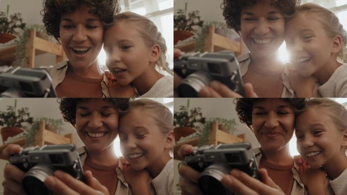 妈妈和女儿看着相机上的照片