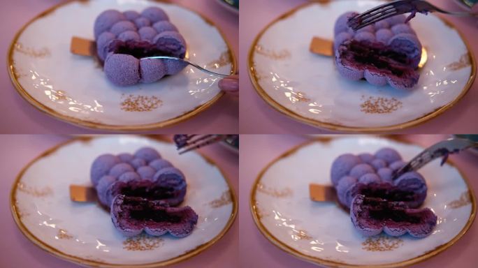 吃一口慕斯蛋糕。吃美味甜美的紫色甜点。餐厅、咖啡馆的糕点。切奶油纹理近距离。吃芝士蛋糕的人。叉子掰断