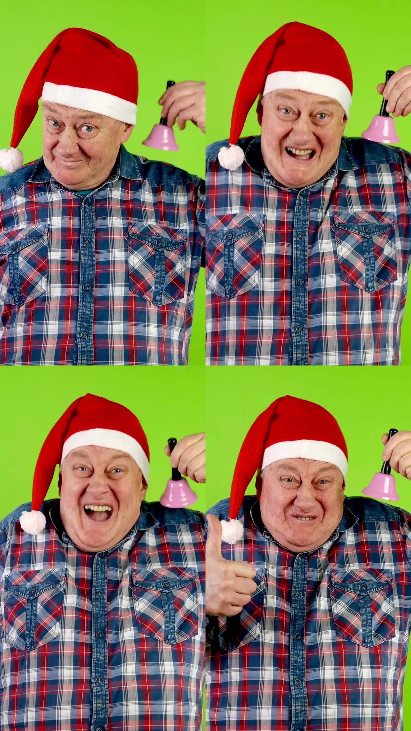 快乐的老人戴着圣诞老人的帽子，摇着圣诞铃铛，笑着。