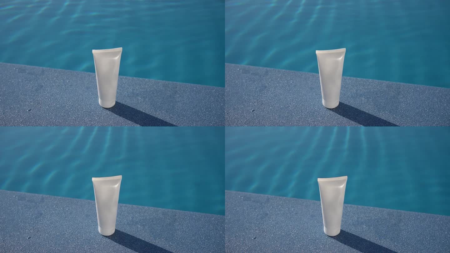 在游泳池蓝色的海水背景下，白天阳光照射下的一管奶油的白色模型。脸部和身体皮肤的润肤霜和防晒霜的概念，