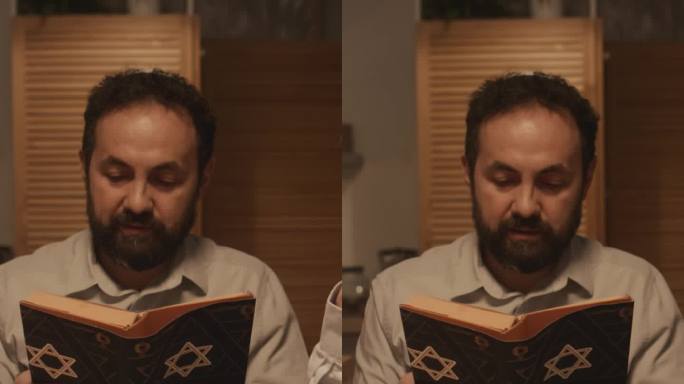 犹太男子在光明节宴会上大声朗读《托拉经》