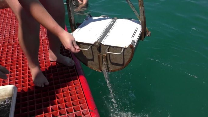 海洋研究:海底动物取样器(抓底器)在科考船的甲板上升起。