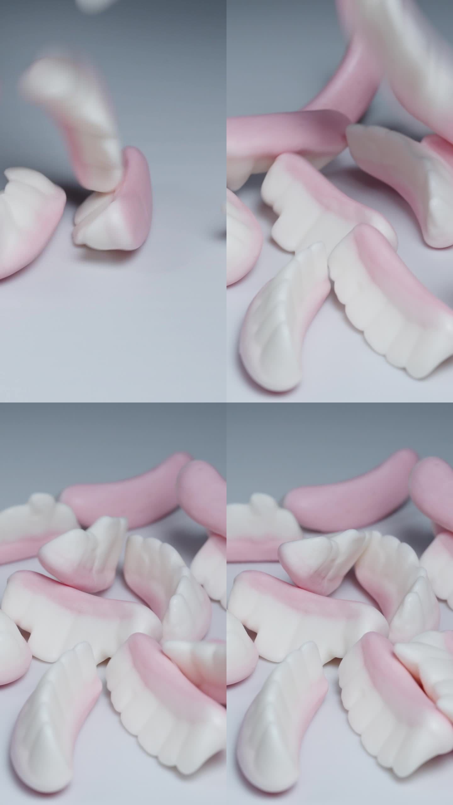 不同牙齿的颌形软糖落在白色的桌子上。