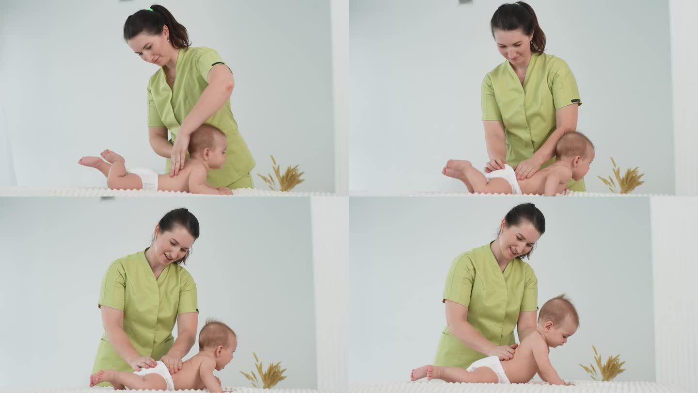 微笑的女按摩师给躺在桌子上的健康婴儿按摩的侧视图。小新生儿在按摩师进行按摩时趴着