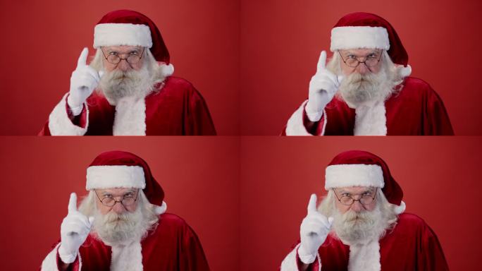 严厉的圣诞老人摇手指，纯红色背景