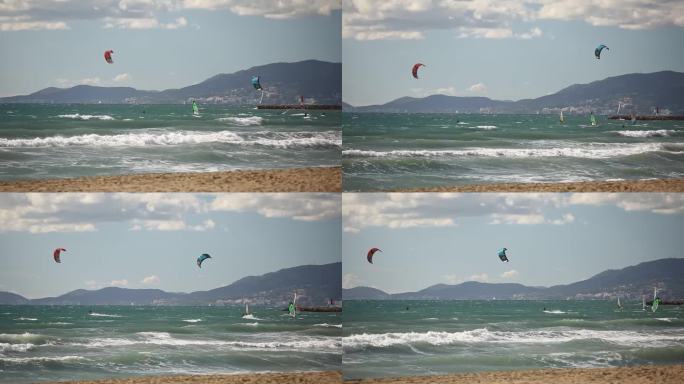 极限水上运动，人们正在西班牙海滩附近的海洋里玩风筝冲浪