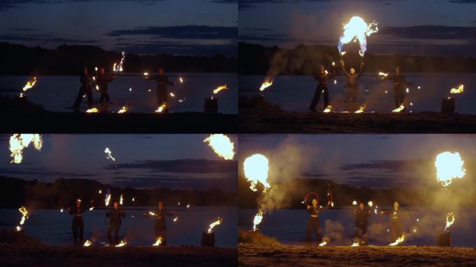 夜江岸边迷人的火焰表演，特技人员玩火