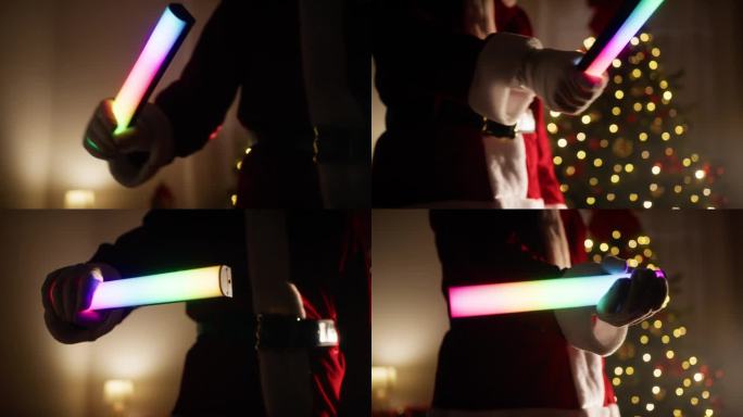 圣诞老人使用彩色的光工具作为光剑
