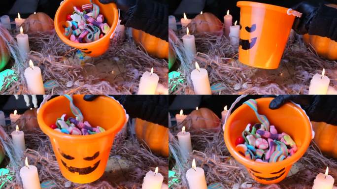 近距离看，可怕的怪物的手在桶里展示糖果。