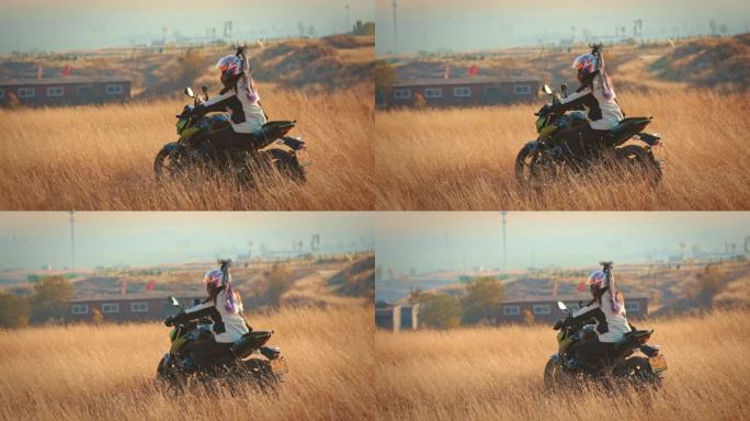 一个女骑手驾驶摩托车在草原上奔跑