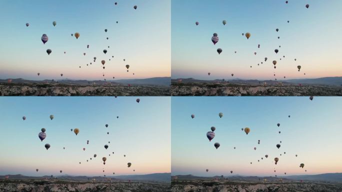 在土耳其，太阳和气球一起升起。空中有很多气球。