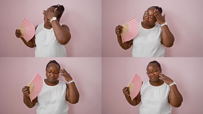 非裔美国妇女用手扇为孤立的粉红色背景热痛苦