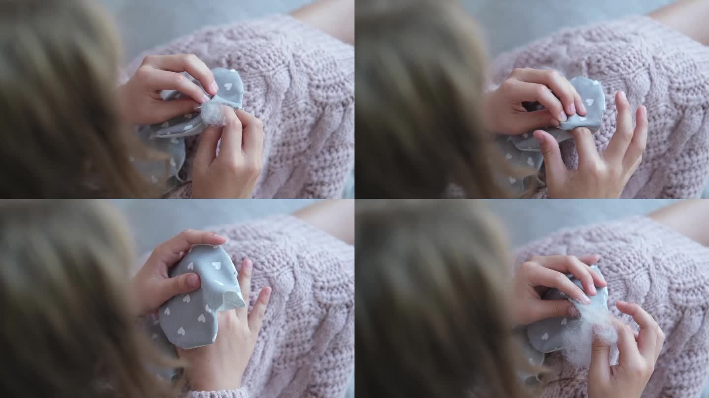 小孩手缝毛绒玩具的特写镜头。这个女孩缝了一个柔软的大象玩具。手工制作的,爱好。