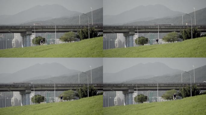 台北滨河公园绿草坪远处火车开过固定镜头