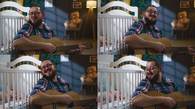 快乐的爸爸深夜在婴儿床旁边唱歌边弹吉他哄孩子入睡