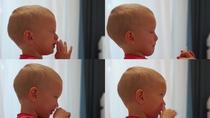感冒流鼻涕的学步儿童使用鼻喷雾剂将溶液喷在鼻子里